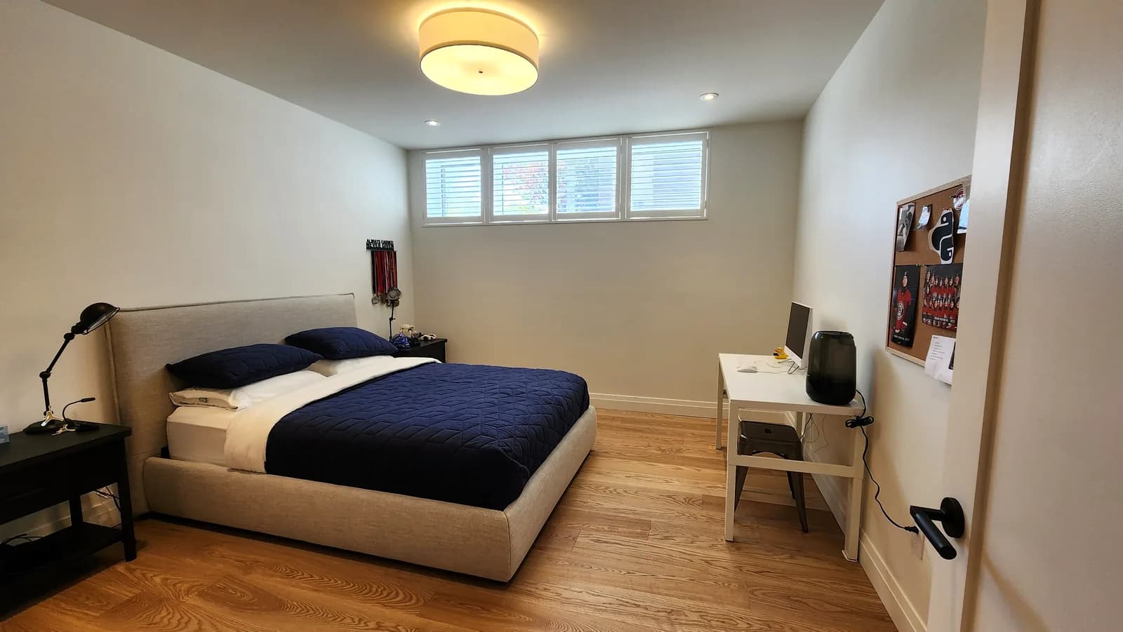 Basement bedroom, wood shutters on the high windows, Town of Mount Royal