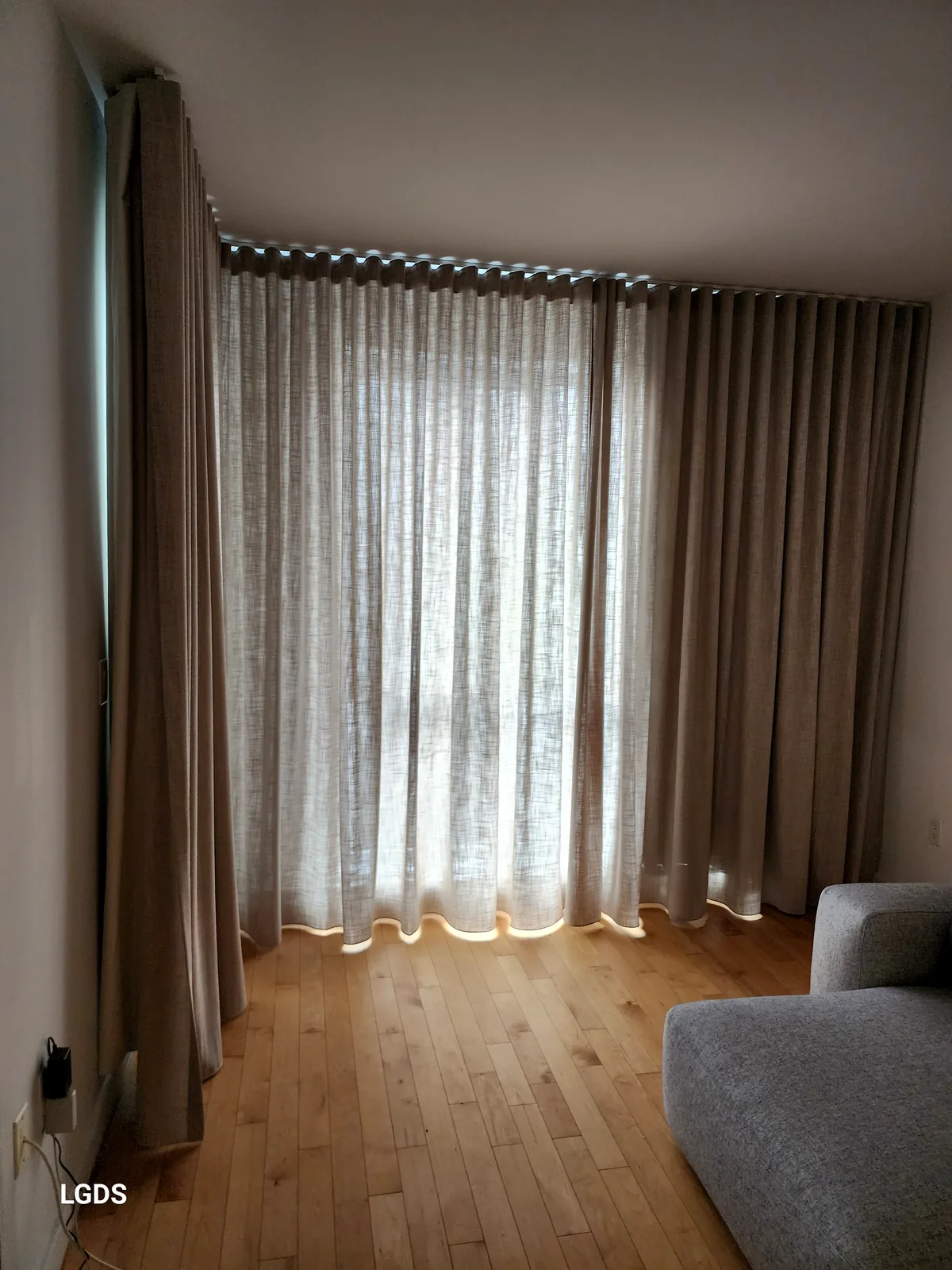 Linen curtains with wave pleats (Ripple Fold) in a condo living room, Montreal