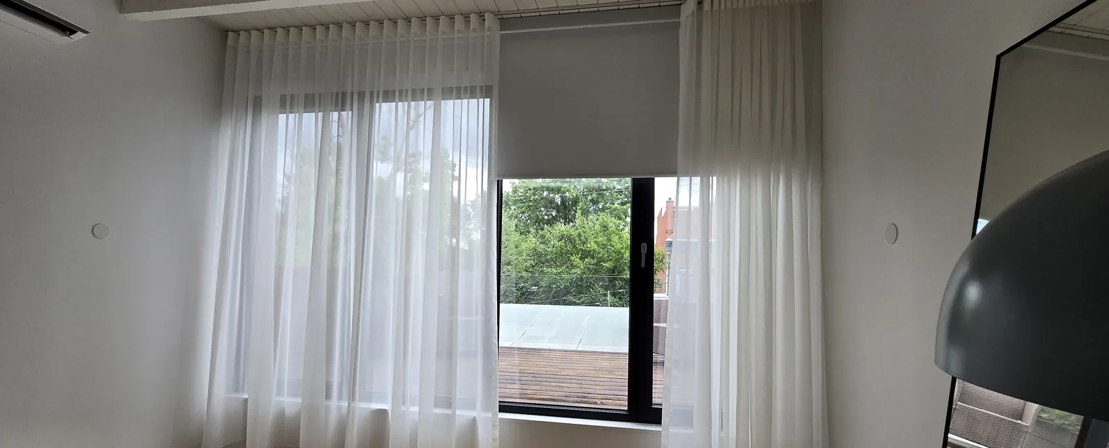 Full-height white sheers on a ceiling track, Montreal (Plateau)