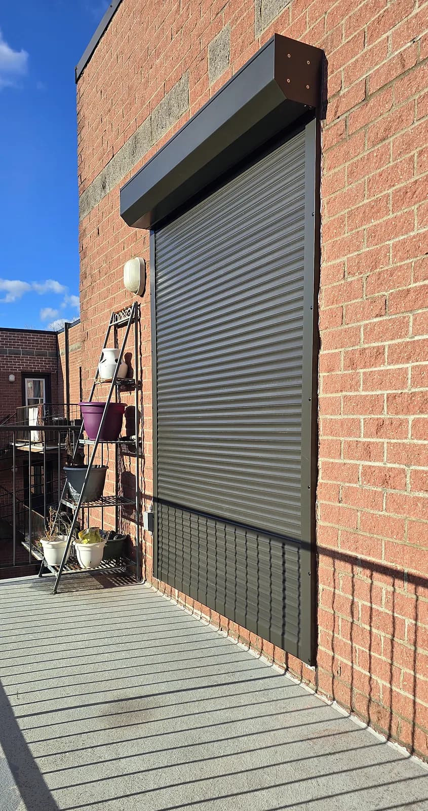 Security roller shutter on a balcony door, brick wall, Montreal