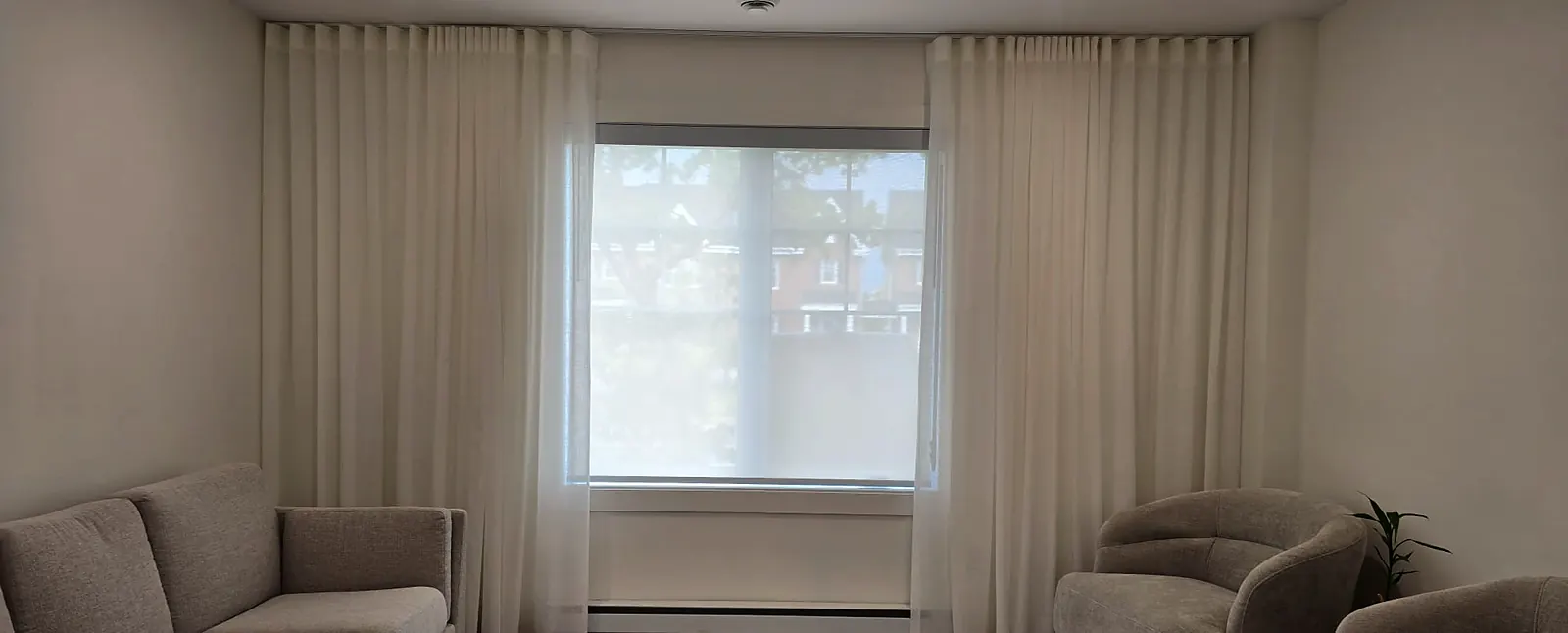 Custom curtains and sheer on each side of a living room window