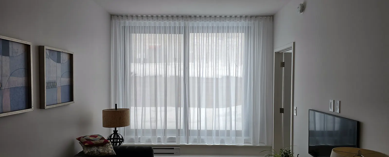 Full-width sheer in a living room in Saint-Laurent